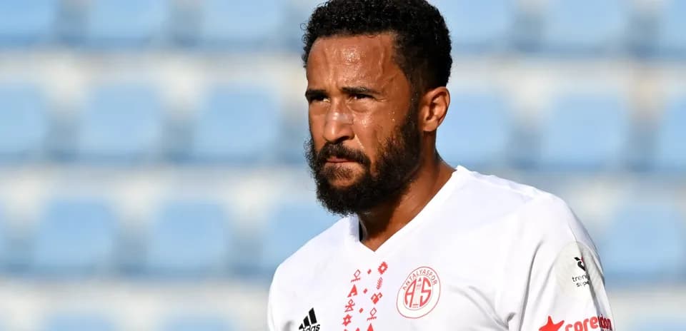 Player in white jersey walking on the pitch