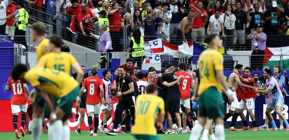Players celebrating on the field after match conclusion