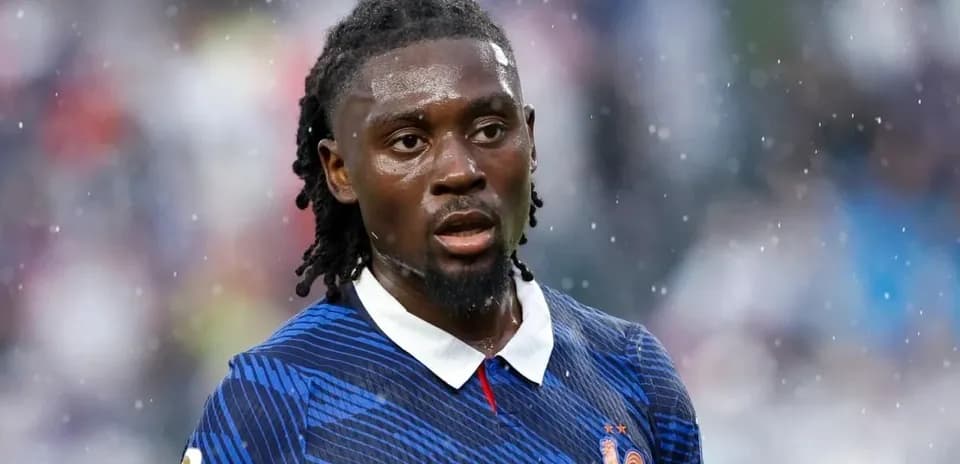 Football player wearing France jersey in rain