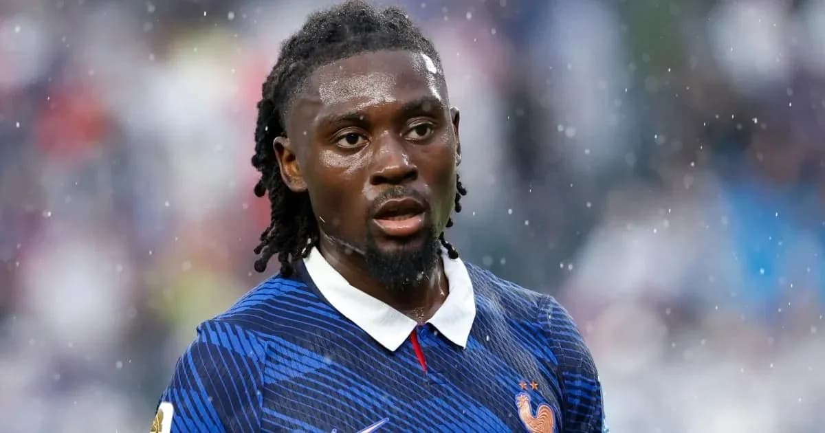 Football player wearing France jersey in rain