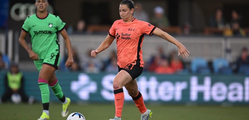 Bay FC player dribbling the ball during match