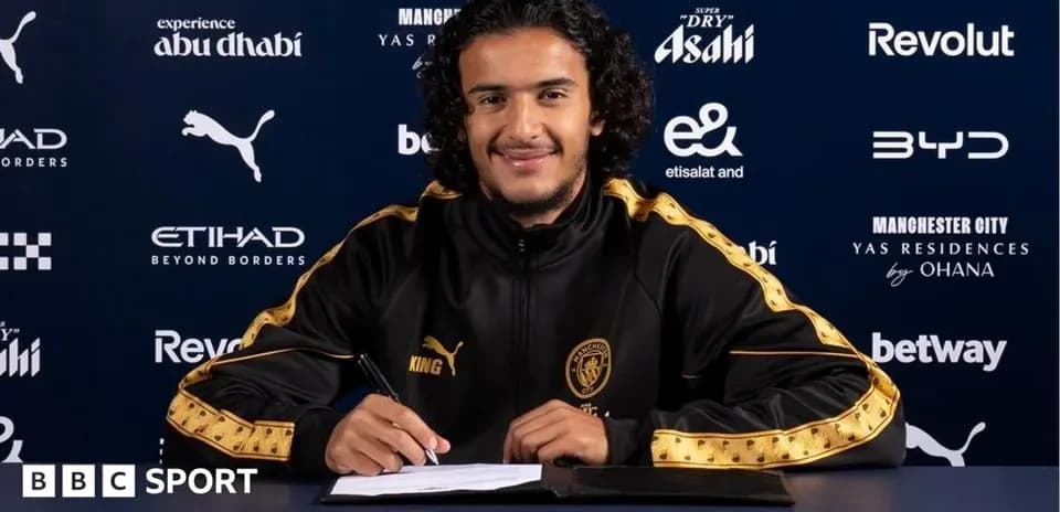Player signing contract at Manchester City press event