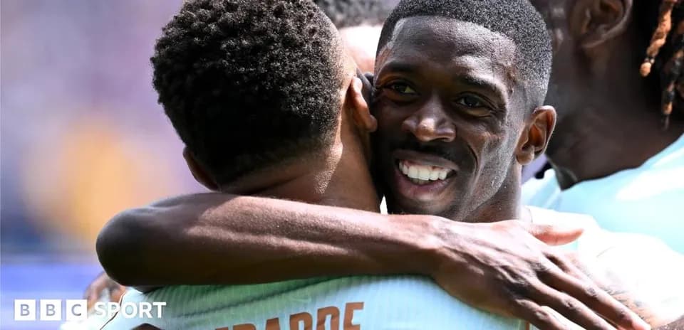 Players celebrating with a hug after scoring