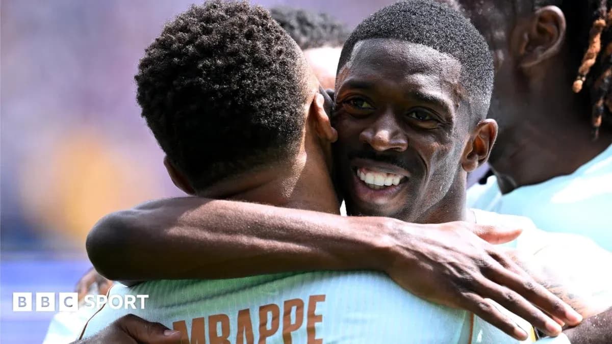 Players celebrating with a hug after scoring