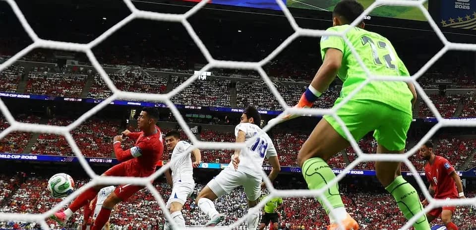 Goalkeeper diving as players contest the ball