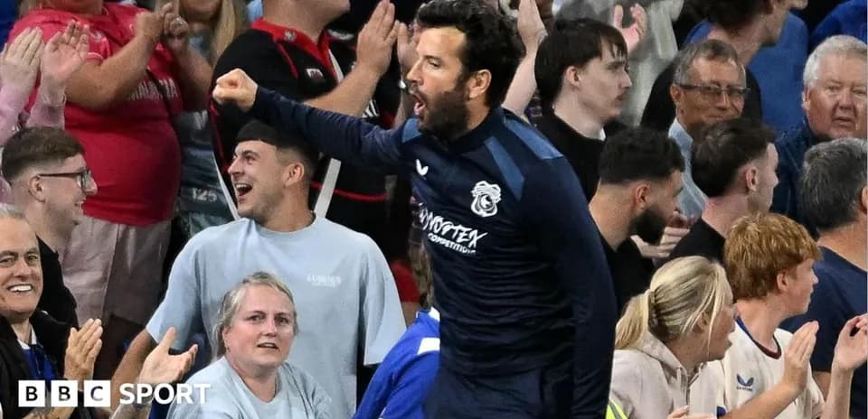 Player celebrating with fans in stadium crowd