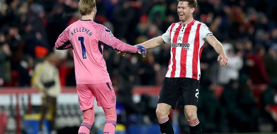 Goalkeeper and defender celebrating after a match