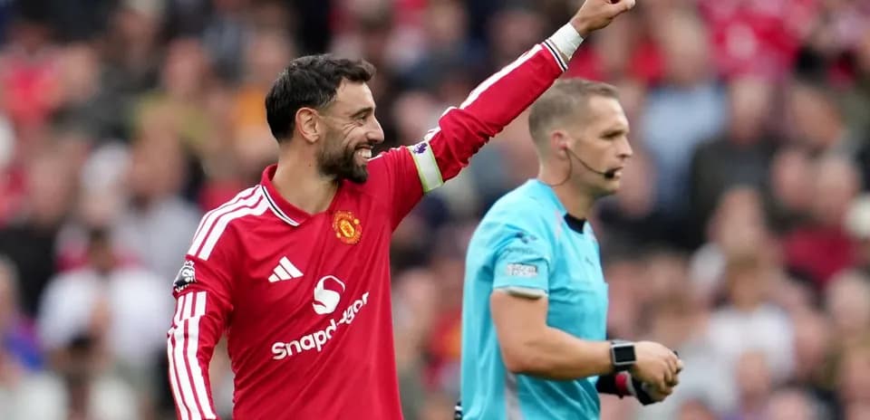 Bruno Fernandes celebrating during a match with referee