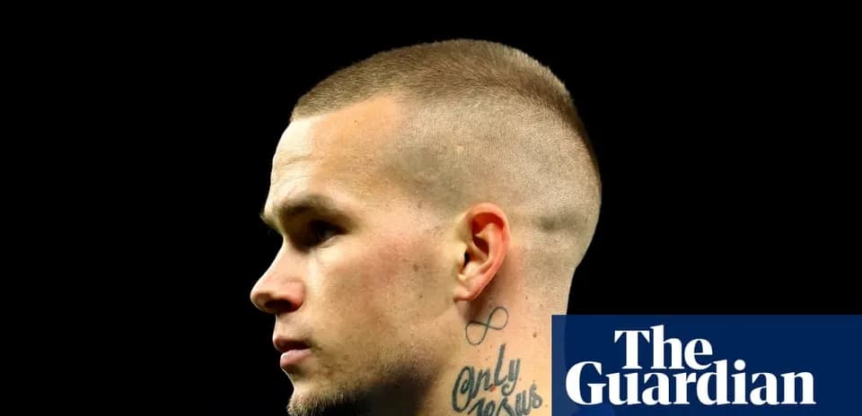 Profile view of player with short hair and tattoos