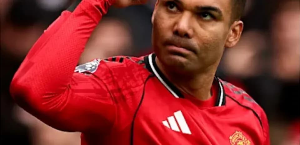Player signaling during match wearing red jersey