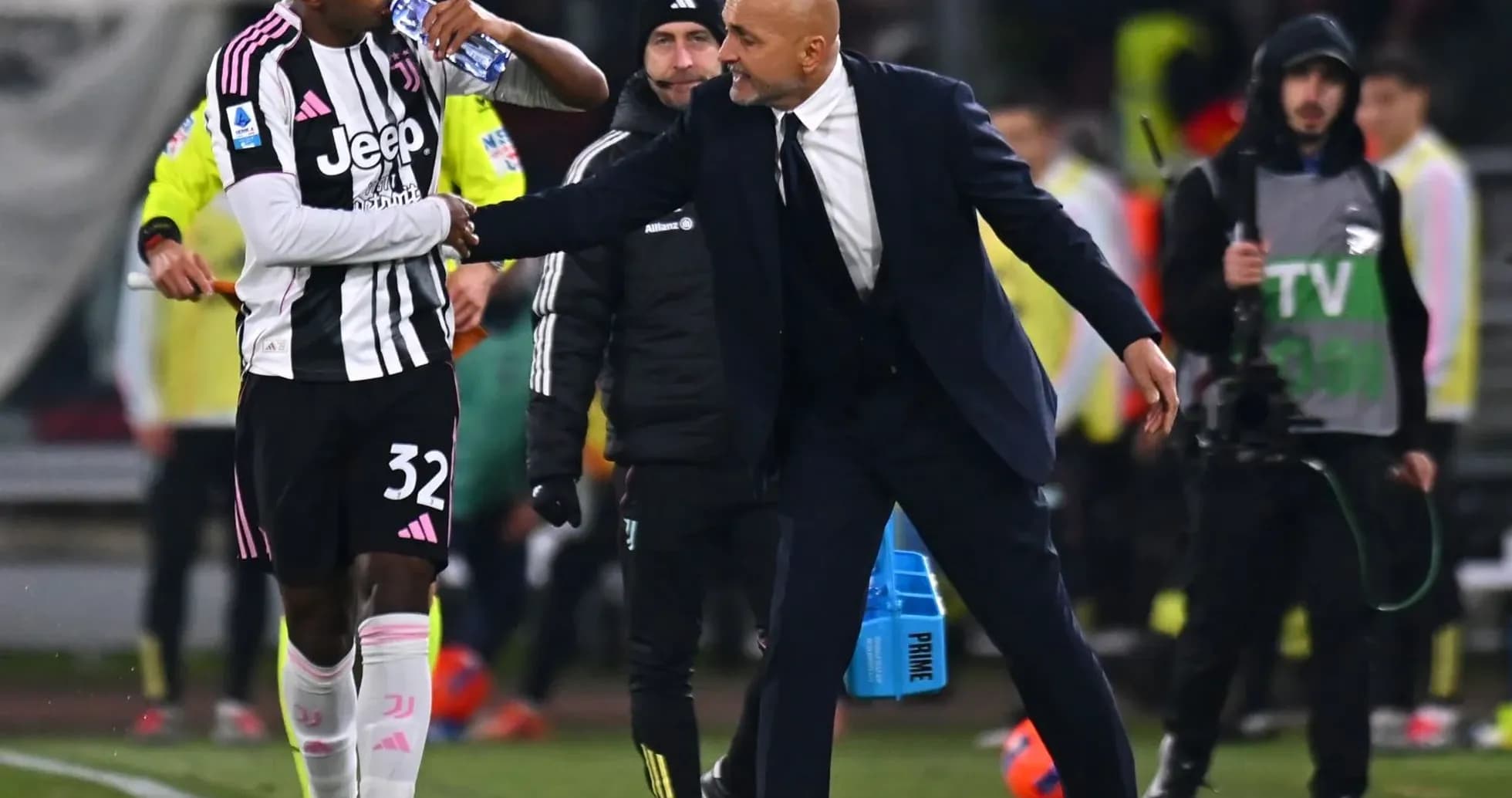 Juventus player receiving instructions from coach