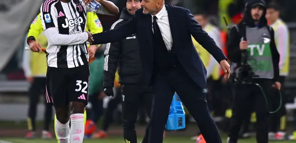 Juventus player receiving instructions from coach