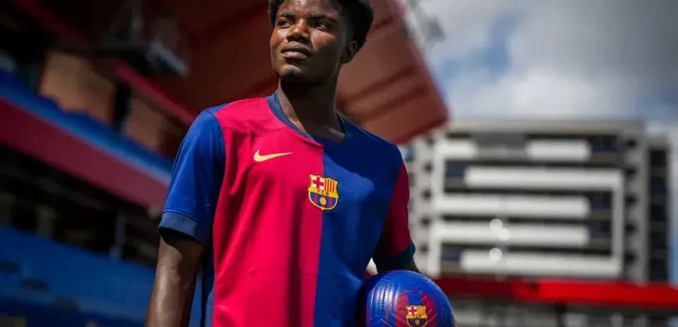 Player posing with ball in FC Barcelona jersey