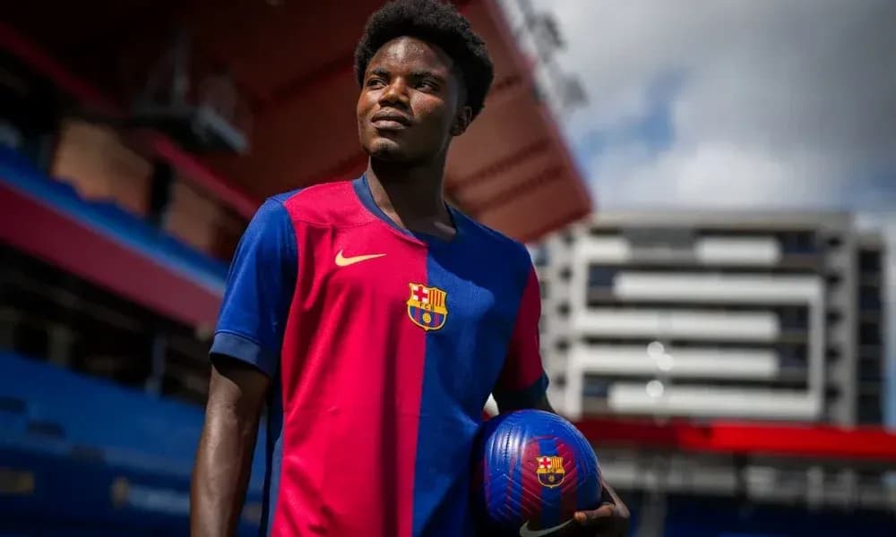 Player posing with ball in FC Barcelona jersey