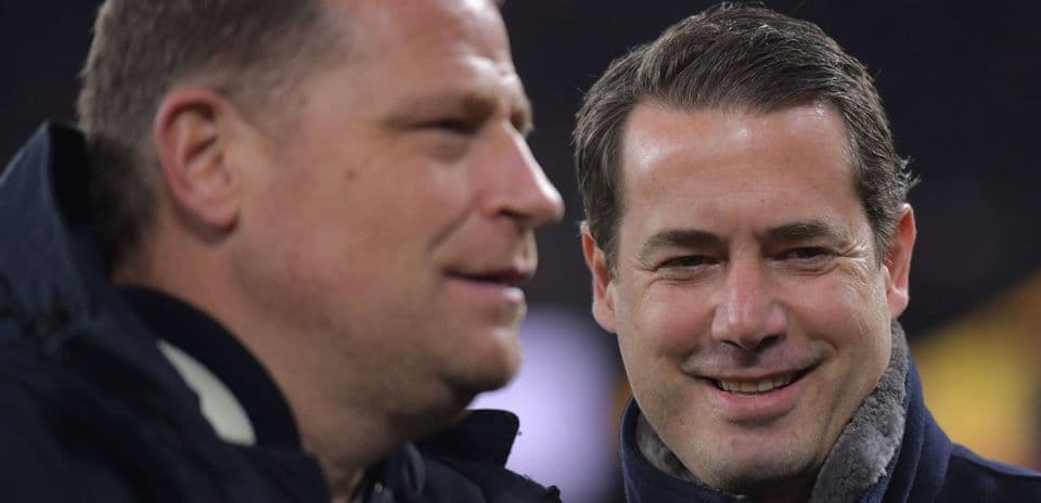 Two men conversing during a sports event