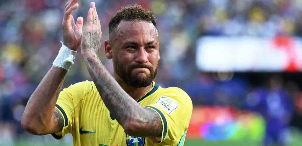 Player applauding fans after match wearing Brazil jersey