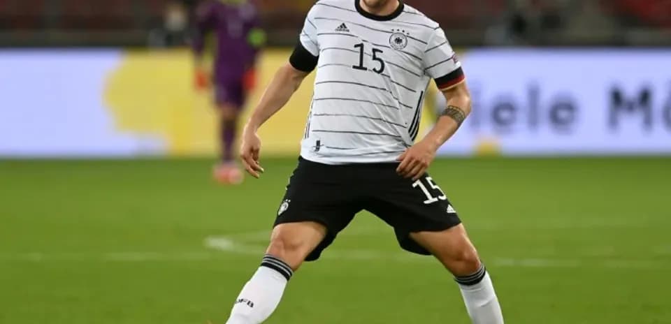 Player in Germany kit controlling the ball during match