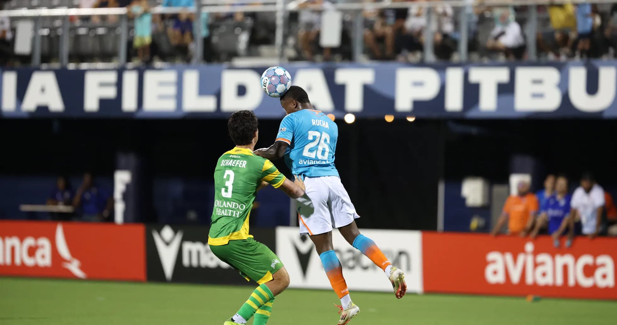 Player heading the ball during Miami FC match