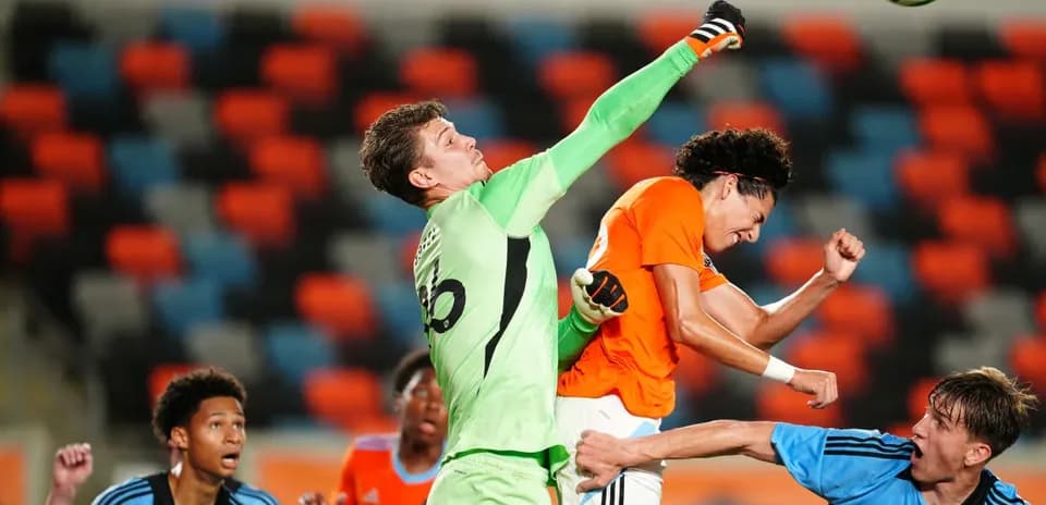 Goalkeeper punching the ball during match action