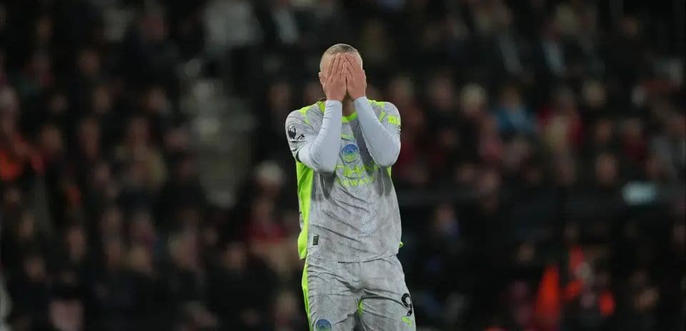 Goalkeeper with hands on face after conceding goal