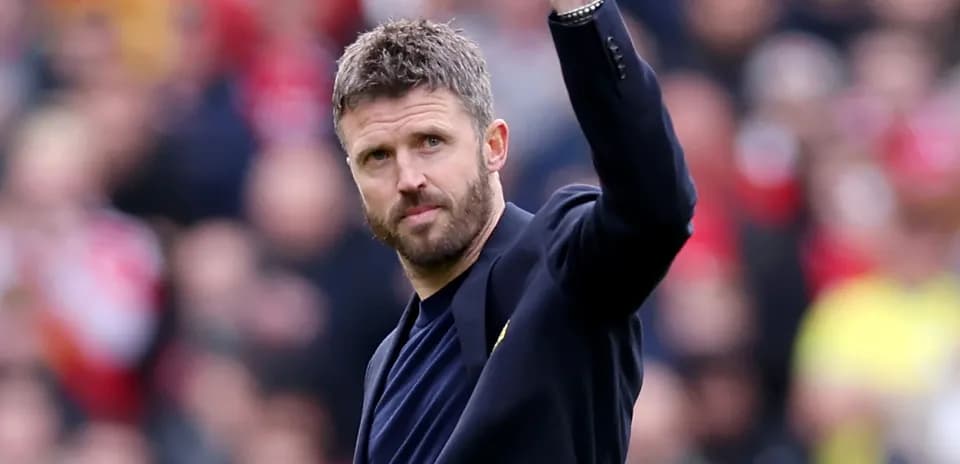 Coach waving to fans during match celebration