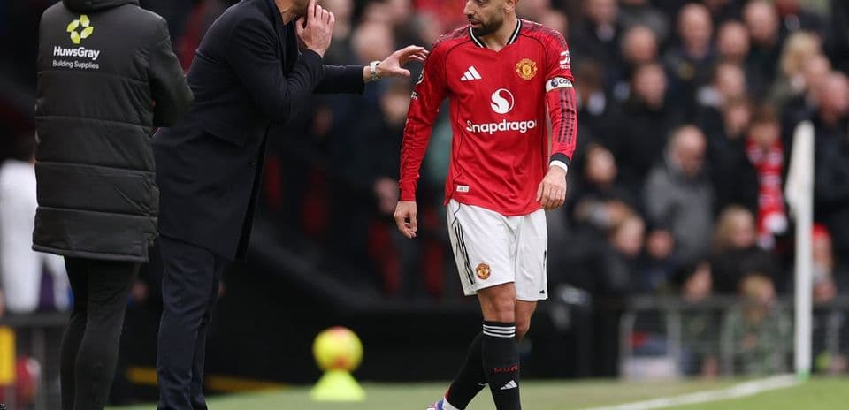 Coach instructing Bruno Fernandes during match