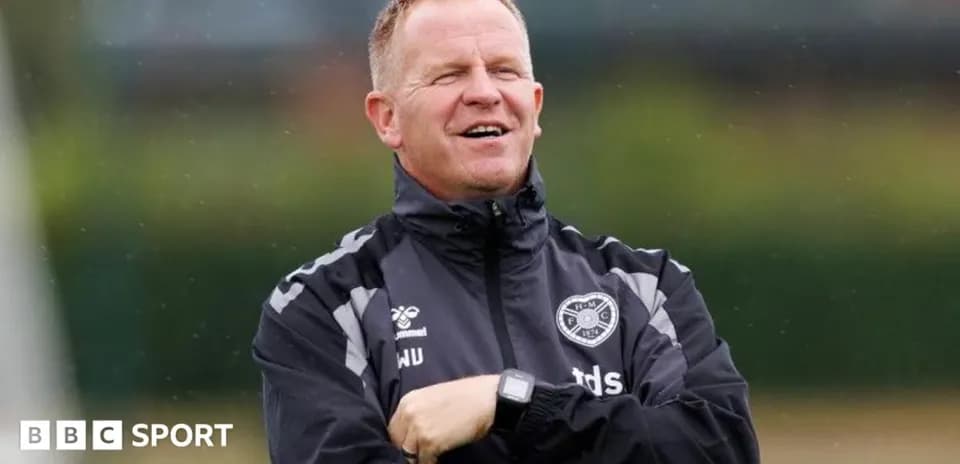 Coach observing players during training session