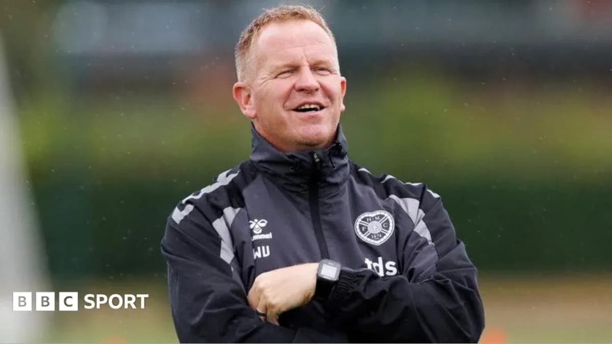 Coach observing players during training session
