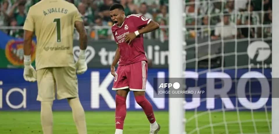 Player reacting during match with goalkeeper in background