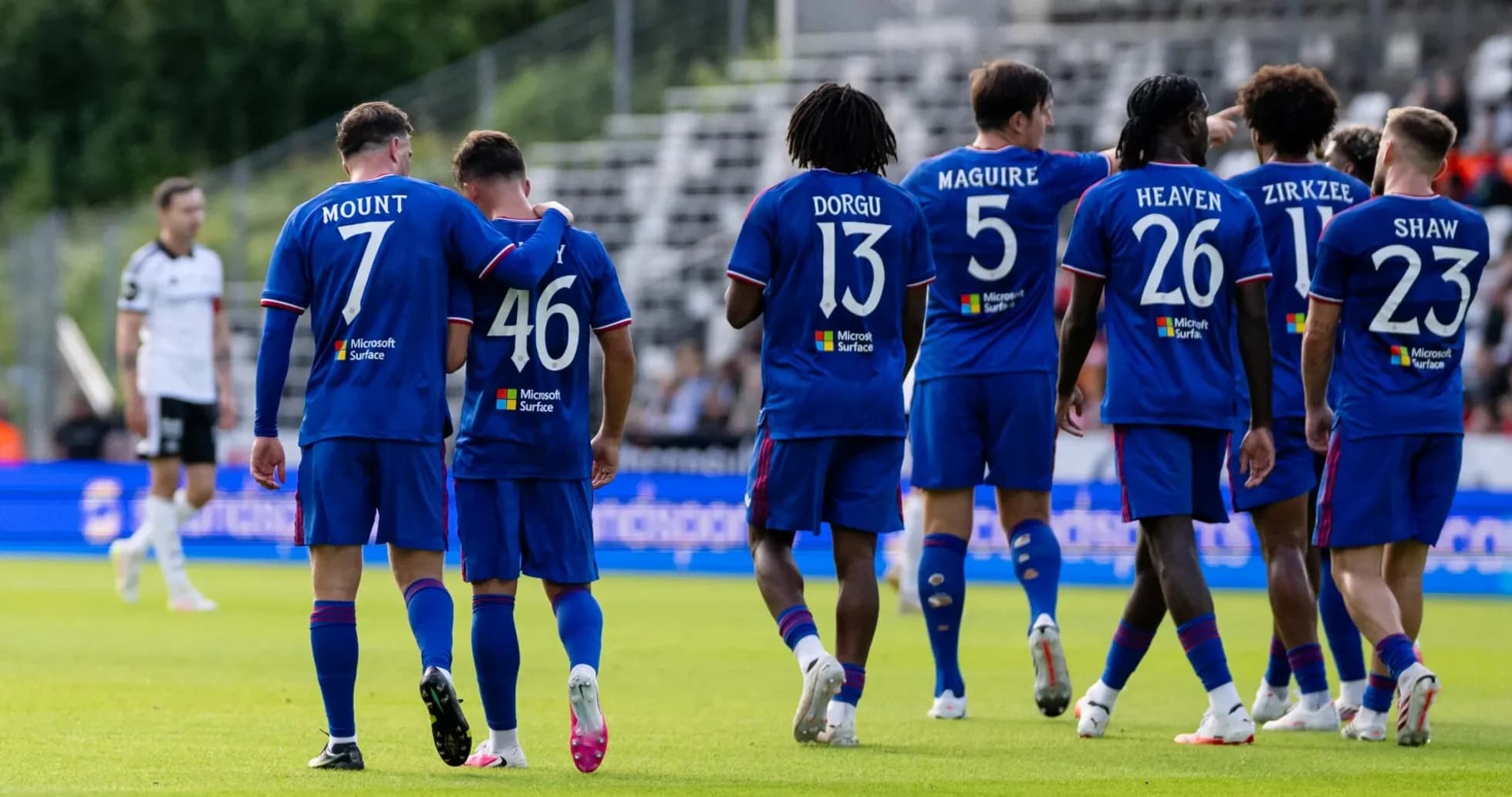 Players in blue jerseys celebrating on the field