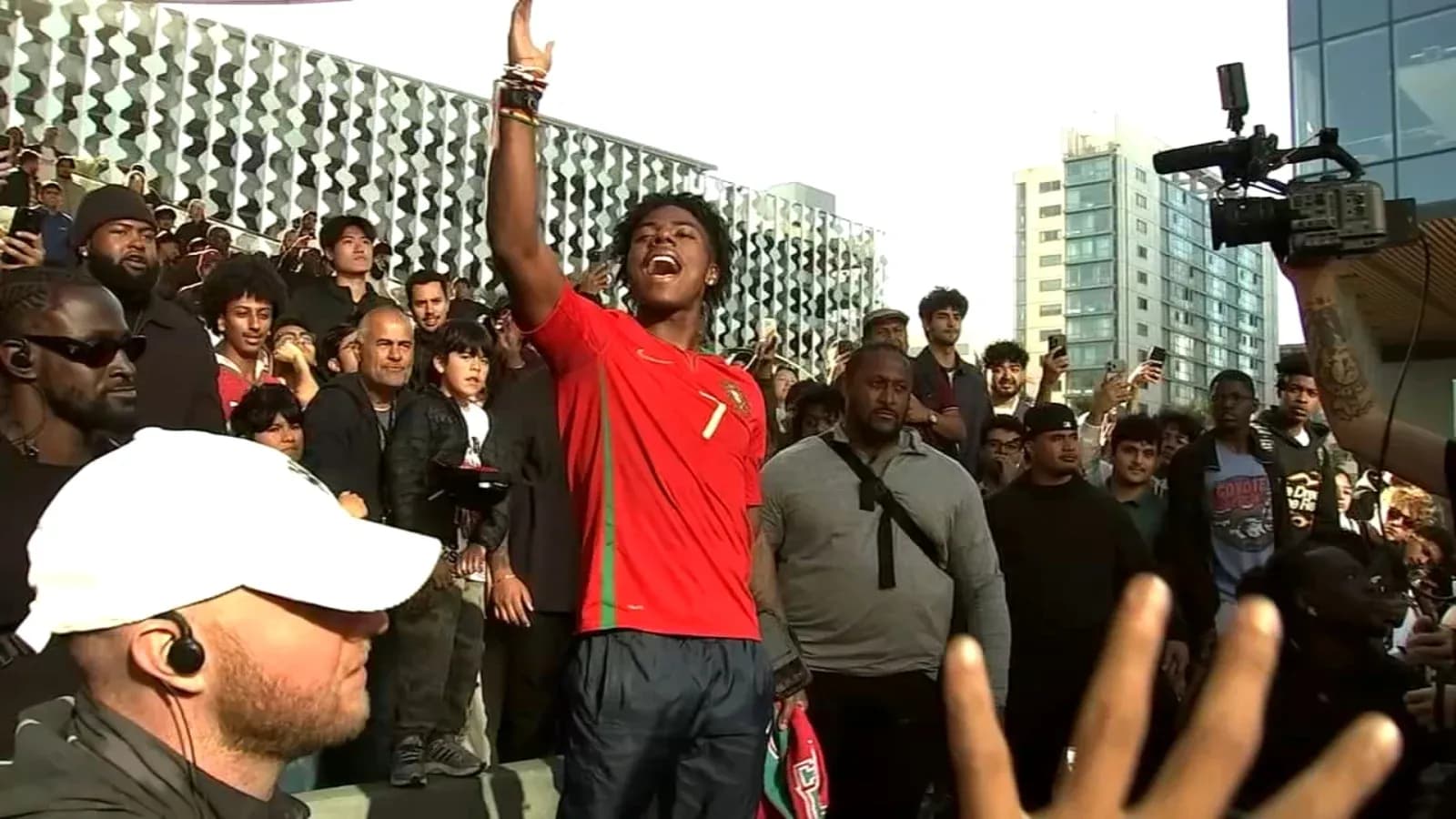 Fan in Portugal jersey leading crowd during event