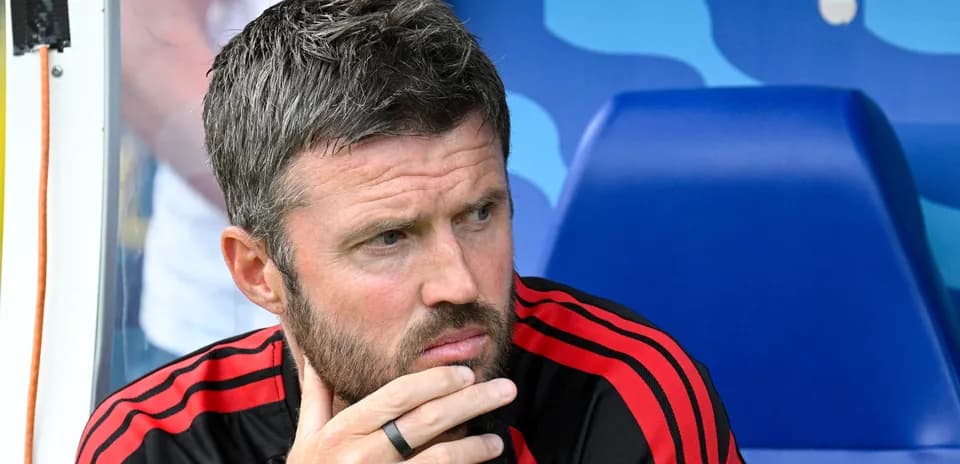 Coach sitting on bench during match preparation
