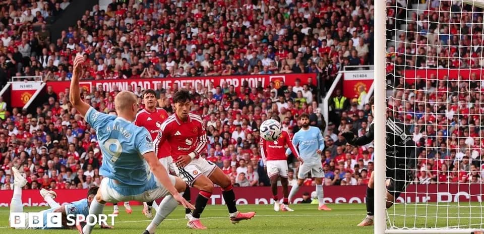 Player attempting to score during Manchester derby match