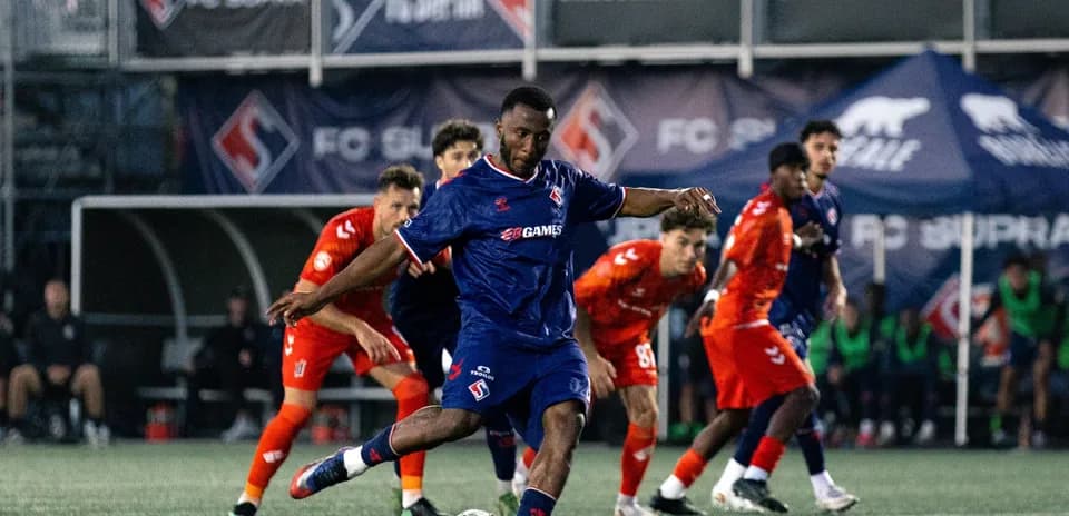 Player kicking the ball during FC Supra match