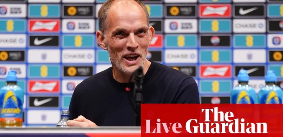Manager speaking at press conference with branded backdrop