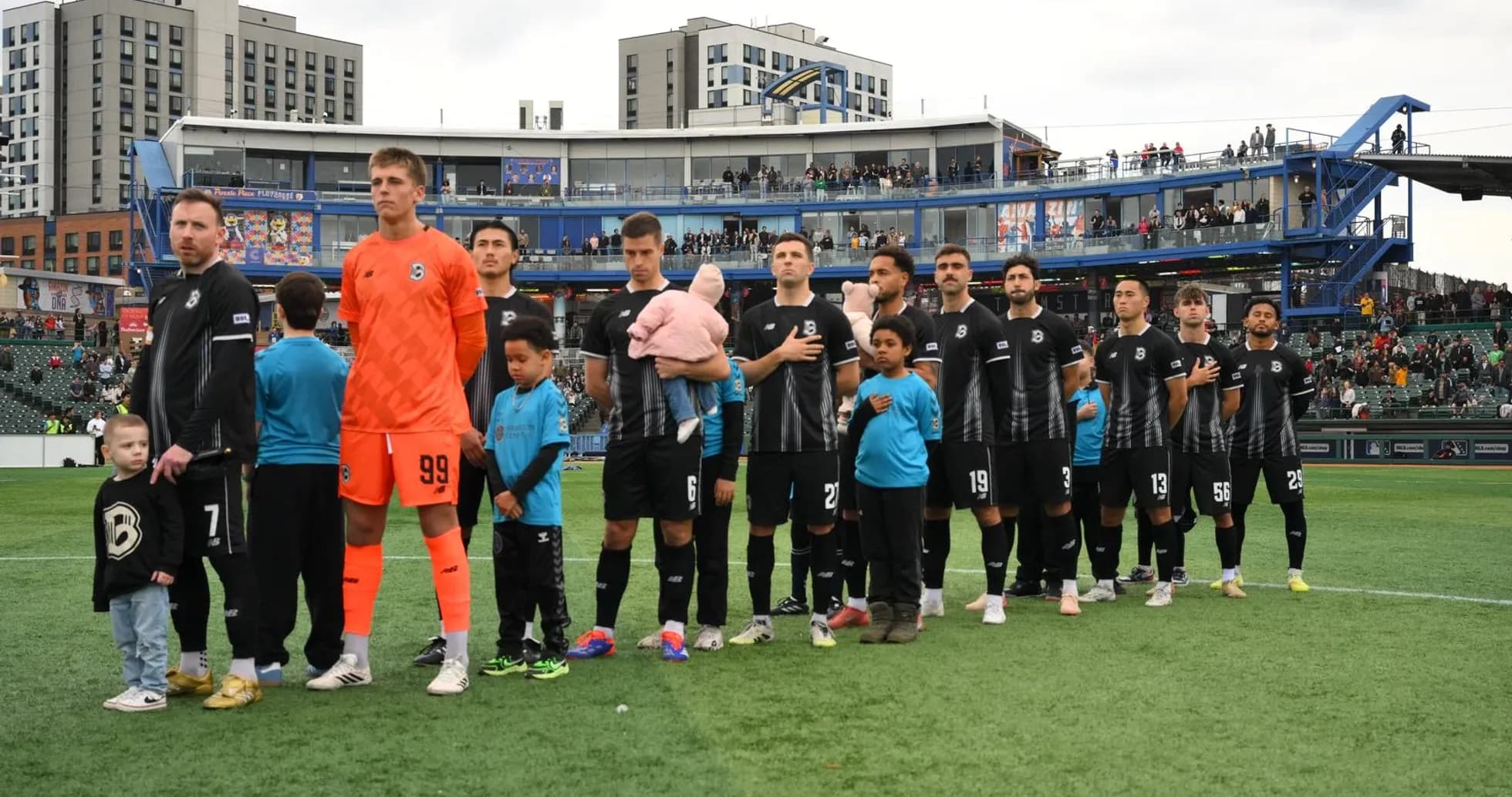 Indy Eleven players standing for national anthem