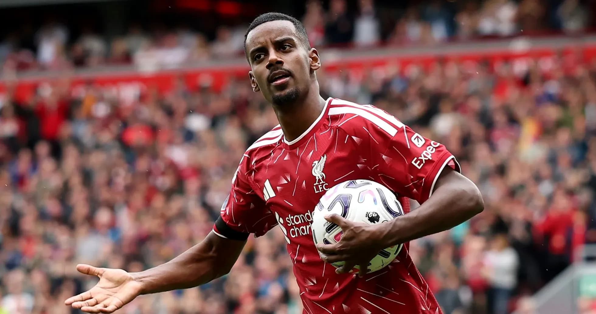 Player in Liverpool kit holding ball during match