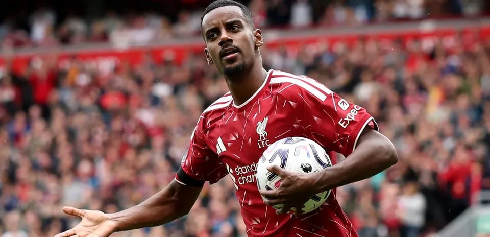 Player in Liverpool kit holding ball during match