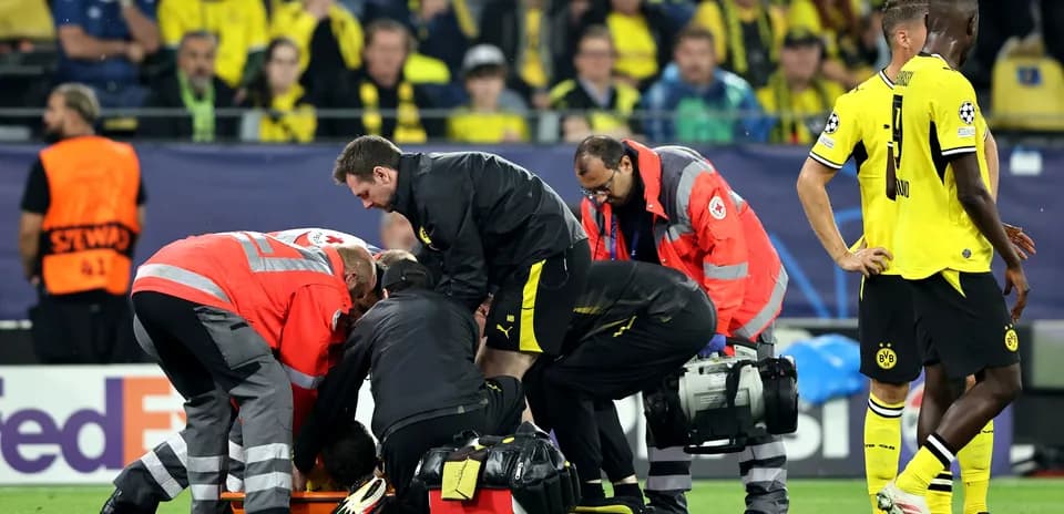 Medical staff attending to an injured player on field
