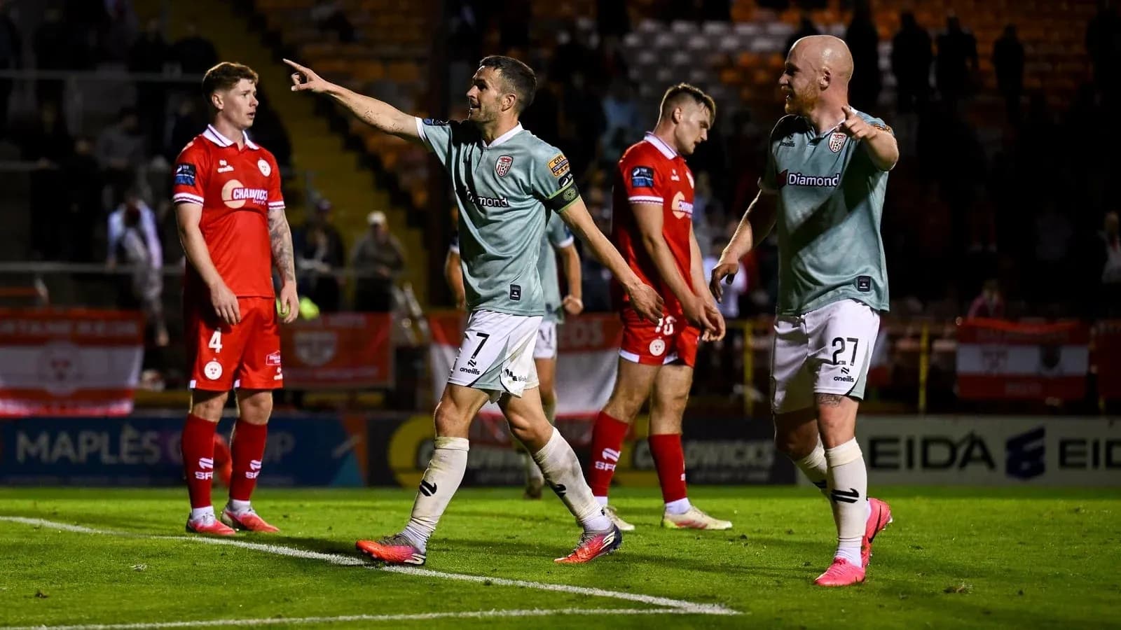 Players celebrating after scoring a goal during match