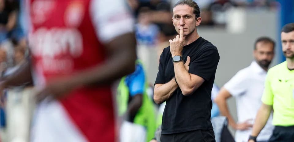 Coach observing match with a finger on lips