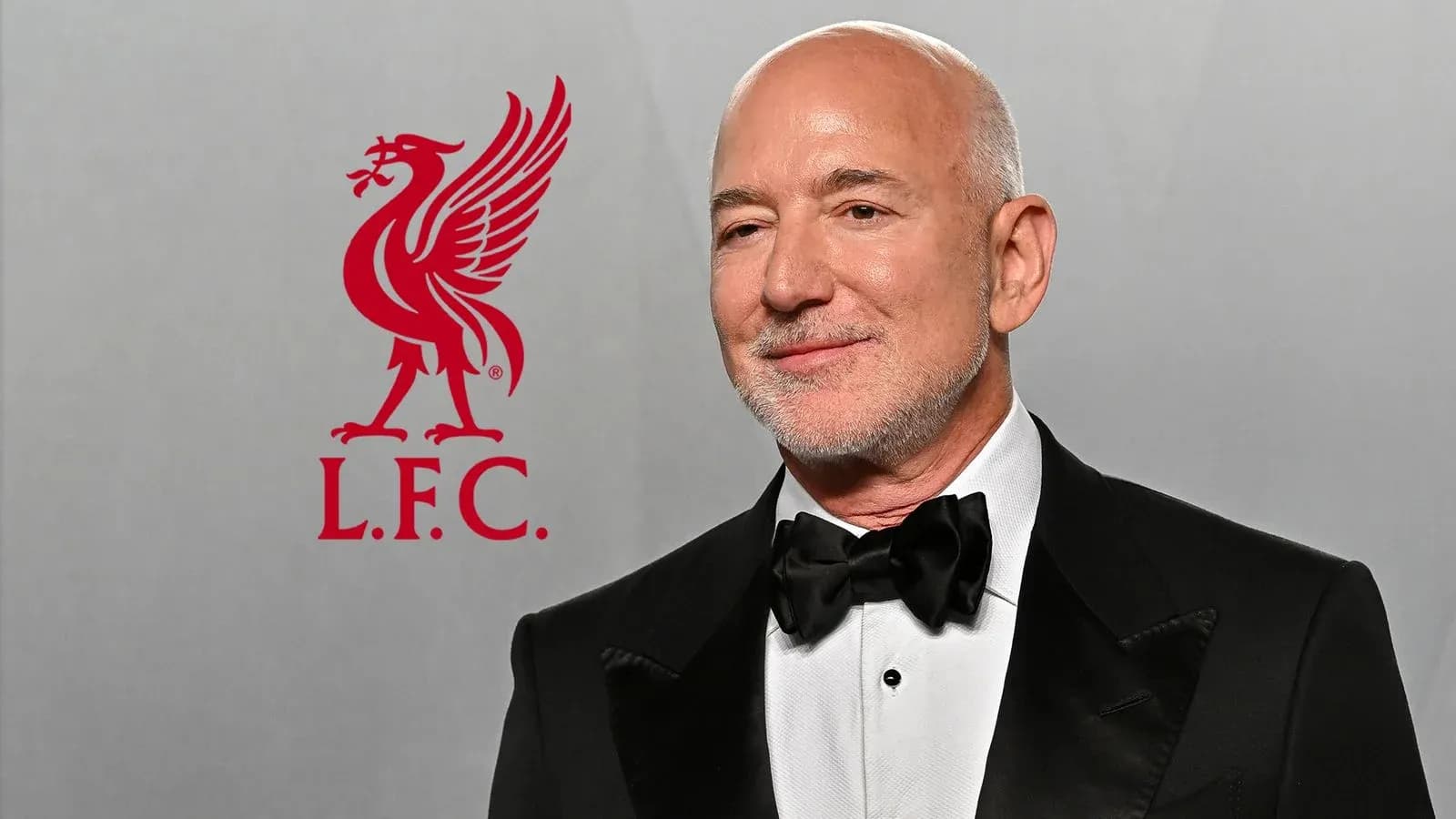 Man in tuxedo with Liverpool FC logo background
