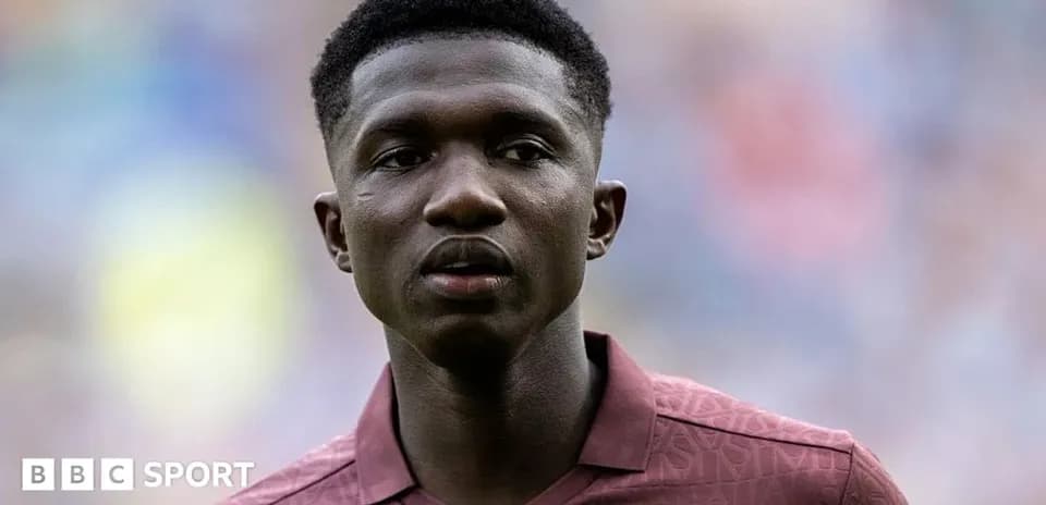 Player in maroon jersey during match warm-up