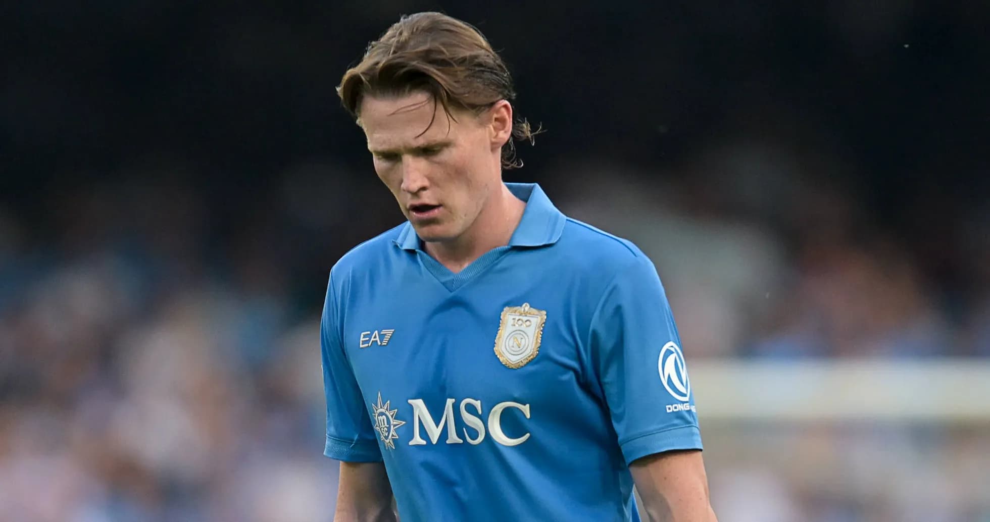 Player in blue jersey walking during match