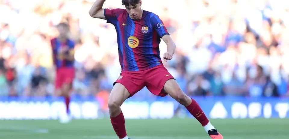 Player in Barcelona kit controlling the ball on field