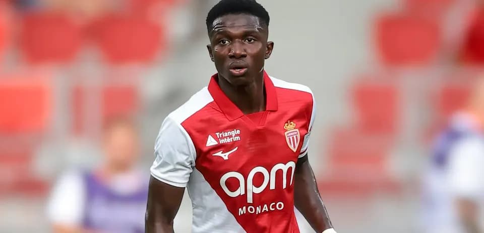 Monaco player in red and white jersey during match