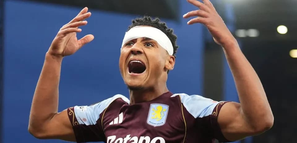 Aston Villa player celebrating with hands raised