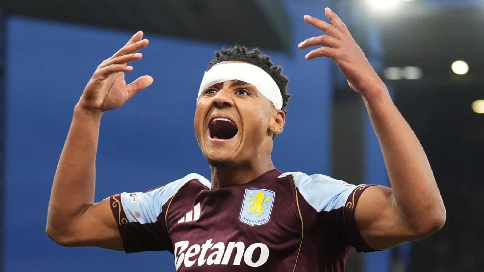 Aston Villa player celebrating with hands raised