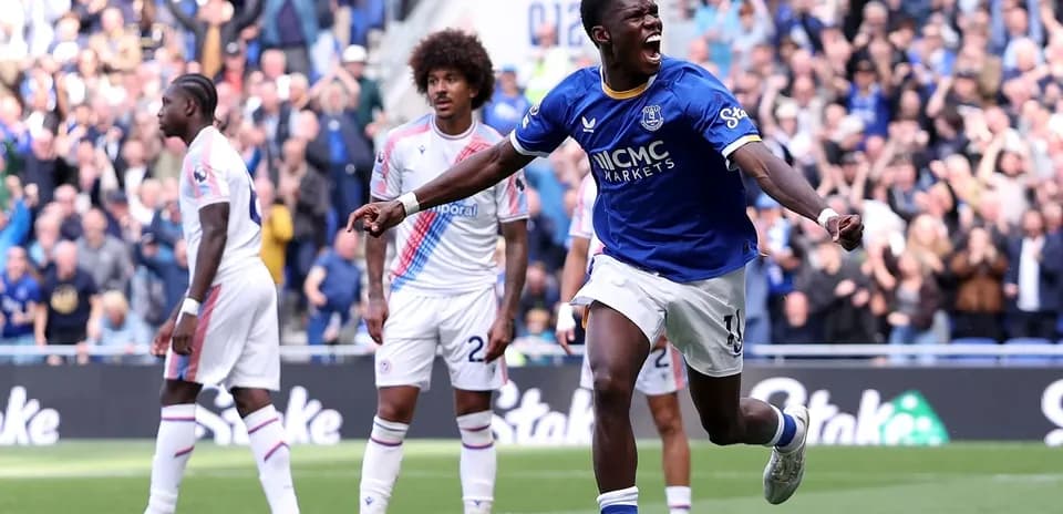 Player celebrating goal with fans in background