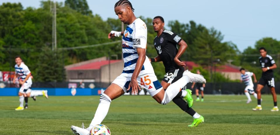 Player kicking ball during Huntsville City match